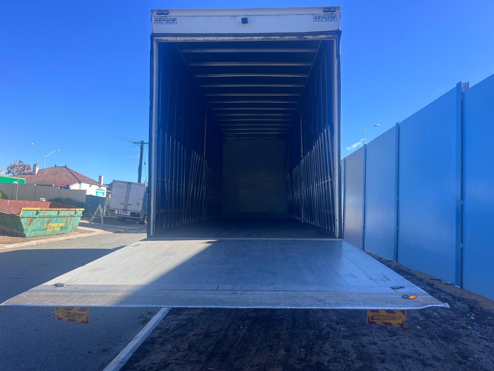 ABS Transport trucking company delivery truck with opened tail lift not loaded